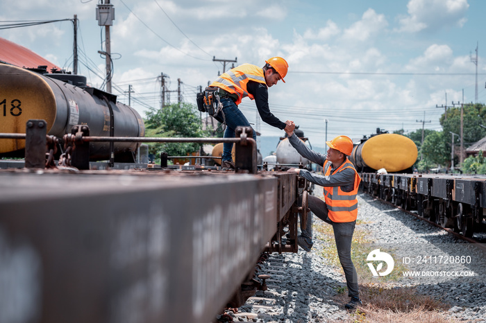 Engineer under inspection and checking construction process railway switch and checking work on railroad station .Engineer wearing safety uniform and safety helmet in work