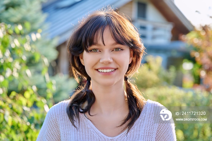 Headshot outdoor portrait of young female 18 years old