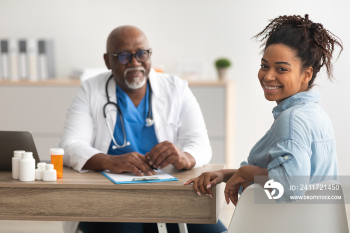 Experienced black doctor explaining treatment plan to patient