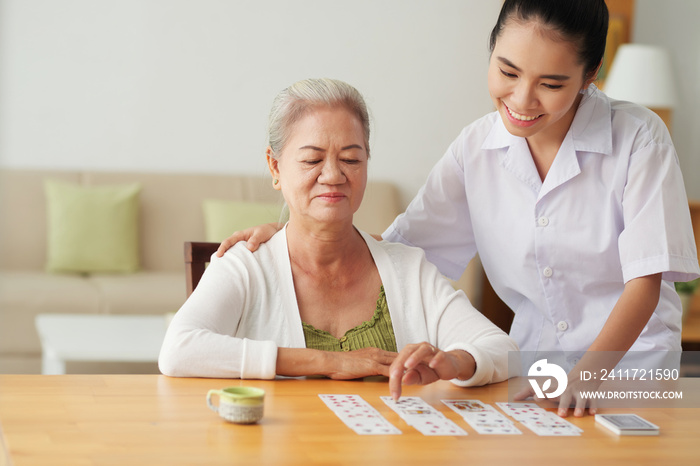 Nurse playing cards with patient