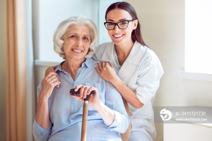 Young woman embracing senior one