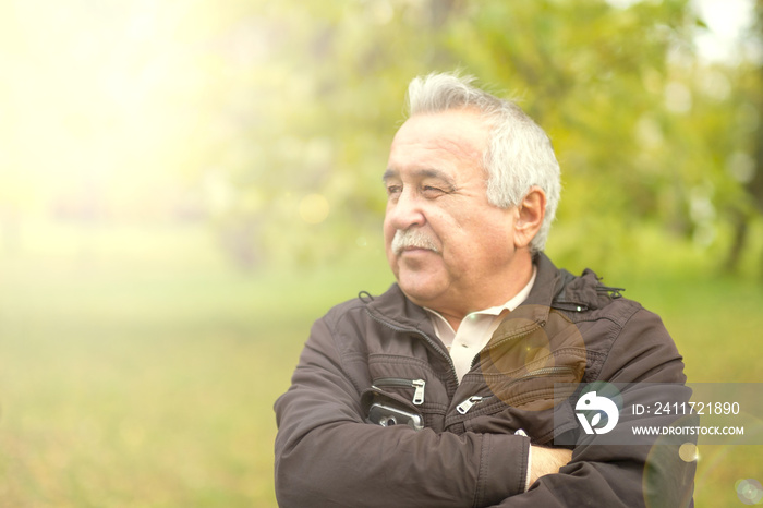 Portrait of an elderly man in the park.