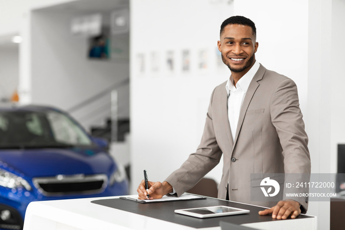 Car Seller Man Standing At Work Desk In Dealership Office