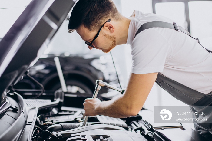 Repair man at car service doing car check up