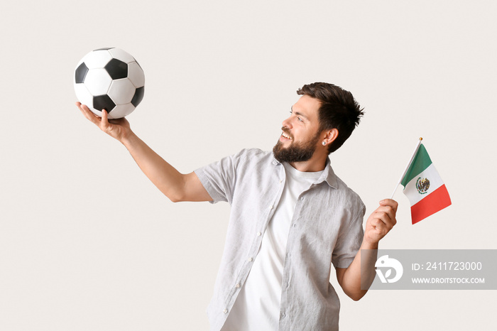 Sport fan with soccer ball and flag of Mexico on light background