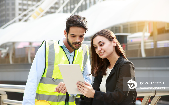 A team of skilled executive engineers is discussing the details of the construction plan