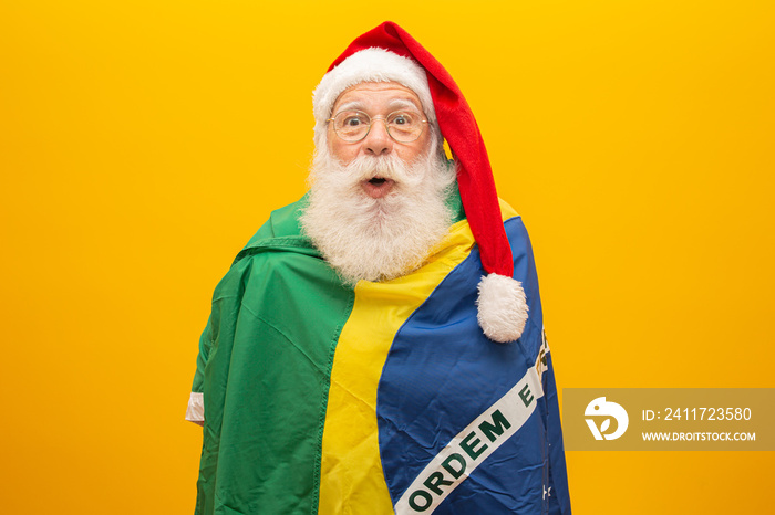 Santa Claus is a fan of Brazil. Santa Claus supporter of the Brazilian team. Sports championship. Santa Claus holding the brazilian flag. Soccer match.