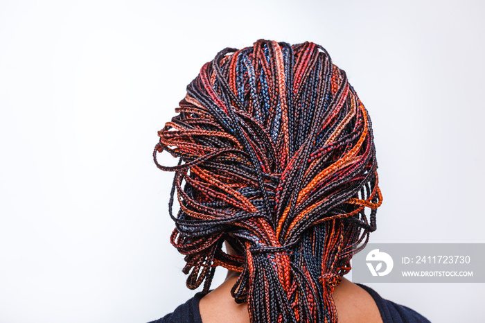 Close-up of afro pigtails braids in Zizi and Kanekalon technique with multi-colored threads and dreadlocks