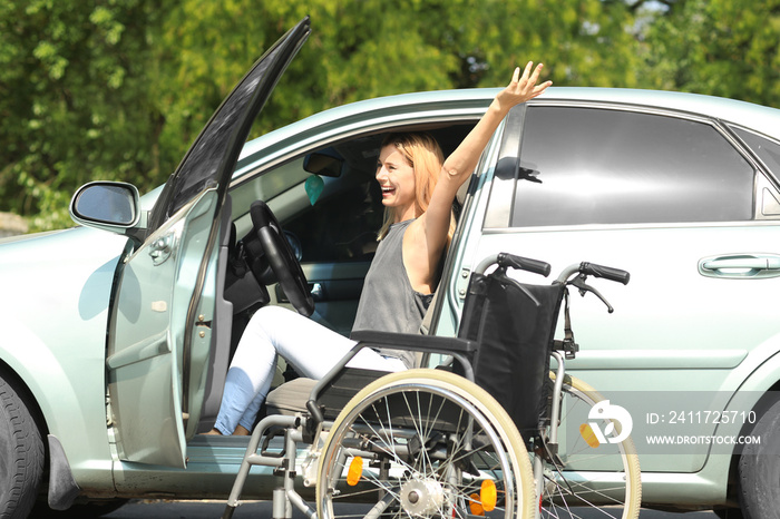 Happy handicapped woman on driver’s seat of her car