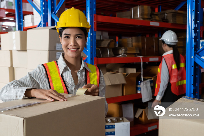 Portrait of young Asian woman warehouse worker smiling in the storehouse . Logistics , supply chain and warehouse business concept .