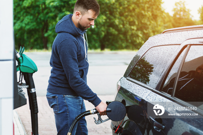 Man is filling tank of his car on the gas station