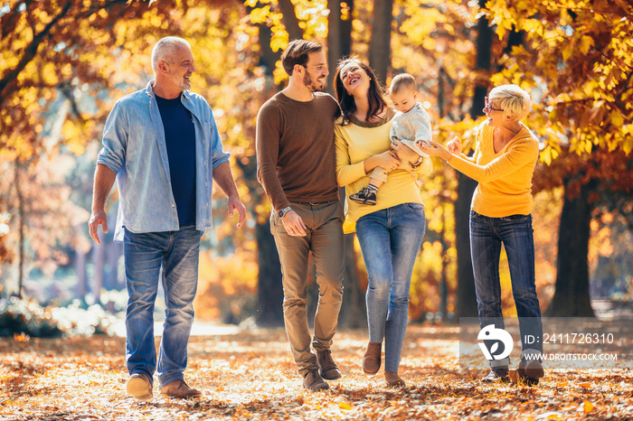 Multl generation family in autumn park having fun