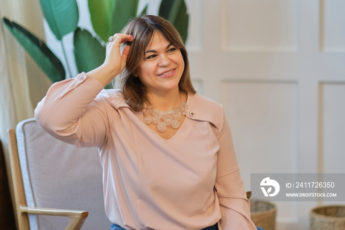 Cheerful senior woman smiling while looking away. Realistic images with their own imperfections