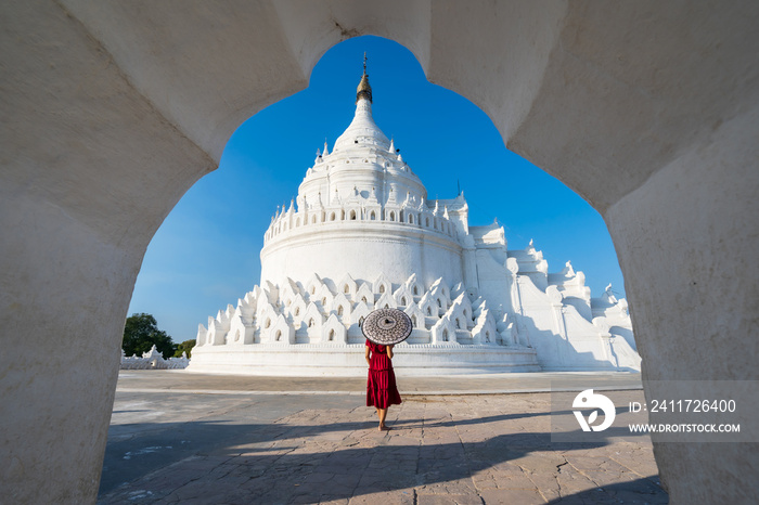 Young woman traveler at Hsinbyume Pagoda (white pagoda) the famous destination in Myanmar