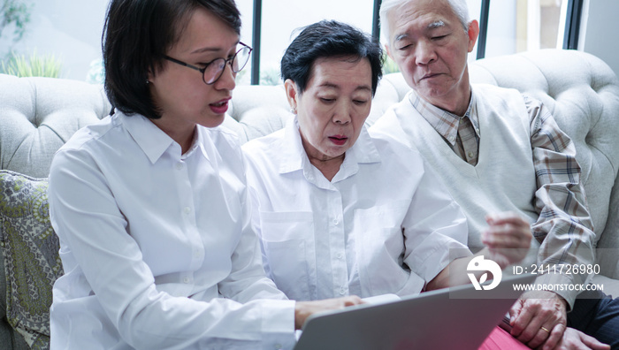 Asian senior couple consult and discuss health plan with woman doctor at home