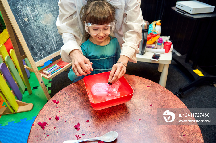 Chemical show for kids. Professor carried out chemical experiments with liquid nitrogen on Birthday little girl.