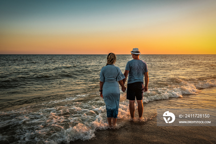 couple looking on the sea at sunset