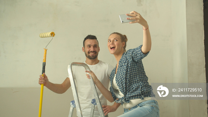 Slow motion, family couple makes a photo during repair