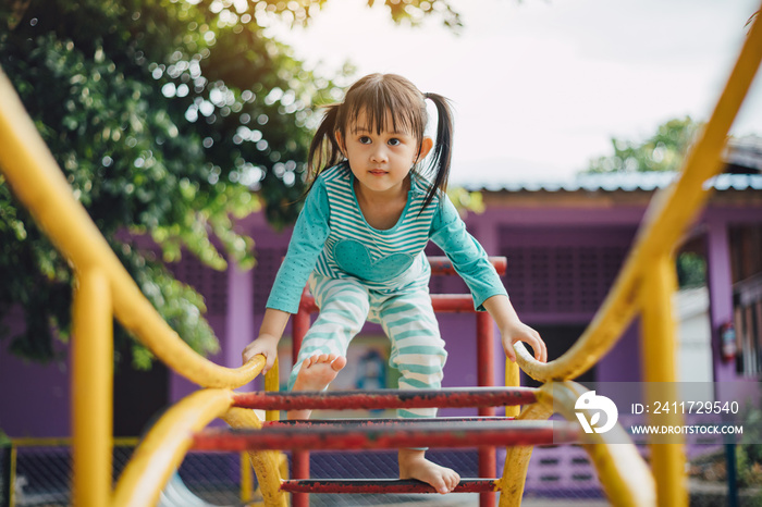 Kids having fun by climbing up ladders at the playground in the park. Education and developmental activity for preschool children concept.