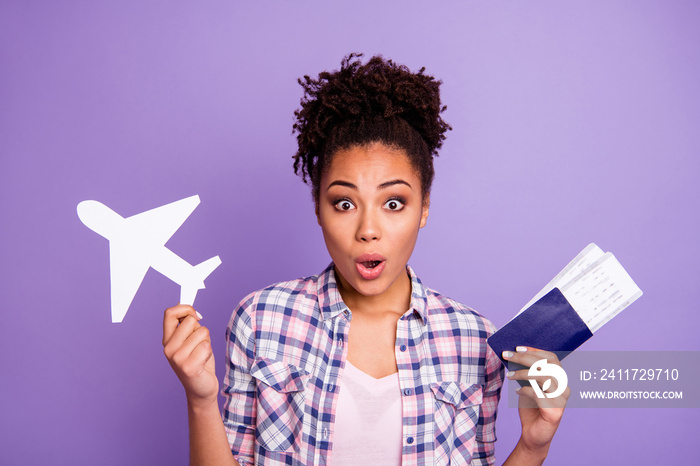 Portrait astonished cute lady impressed unbelievable unexpected news hold hand paper plane free time open mouth wow wonder beautiful top-knot isolated wear stylish checked shirt purple background