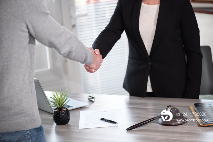 Handshake between female lawyer and male client