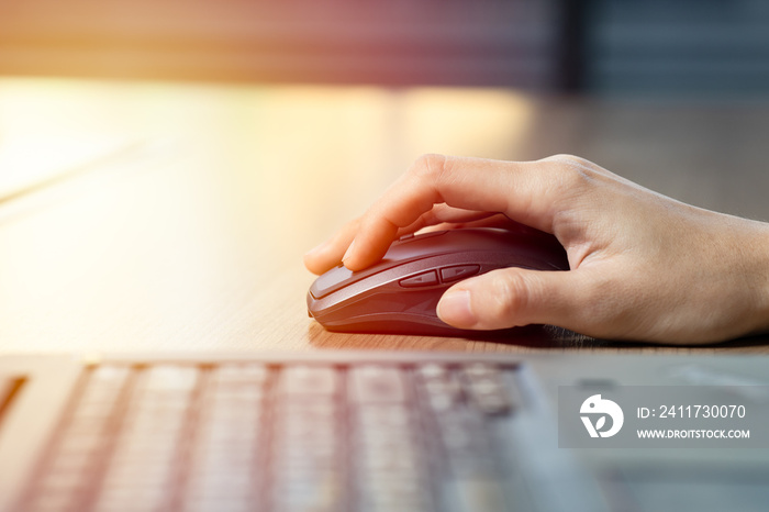 Close up of business woman hand using mouse with computer laptop for working in office.