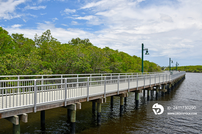 Fishing, walking pier along the St Lucie River estuary in Port St Lucie, Florida