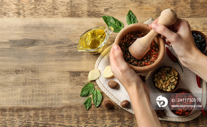 Female hands grinding spices in mortar