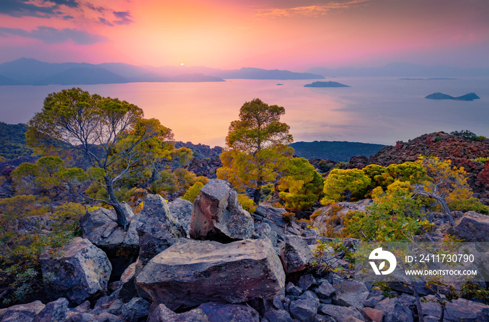 Incredible sunset on popular tourist destination - Methana Volcano with Saronic Islands on background. Rocky evening scene of Peloponnese peninsula, Greece, Europe. Colorful Mediterranean seascape.