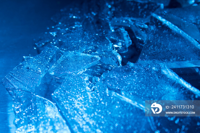 Macro photo of a cracked blue ice texture background.