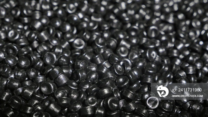 Plastic black gray granulated crumb. Manufacture of plastic water pipes of the factory. Process of making plastic tubes on the machine tool with the use of water and air pressure.