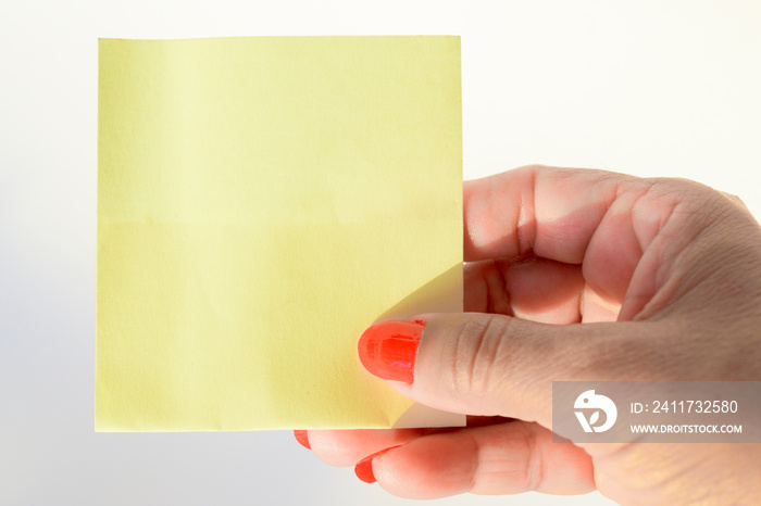 Woman’s hand with painted nails holding blank letter paper on pure white background