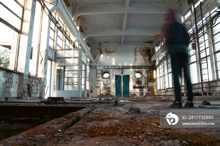 Person standing in half ruined house