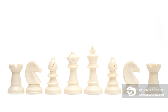 Set of white chess pieces are lined up isolated on a white background.