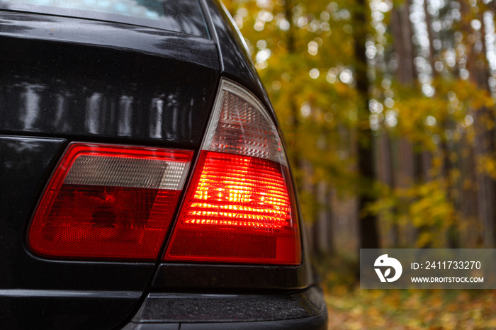 Rear end close up BMW E46 red car lights.