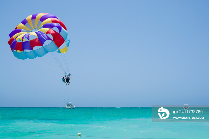 Colorful parasail wing flying over turquoise water of Sargasso Sea, Punta Cana, Dominican Republic