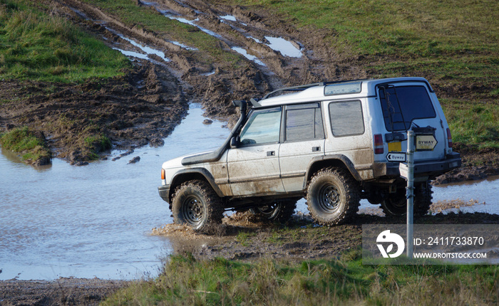 4x4 land rover discovery series II off roading, wading in deep water and slippery mud