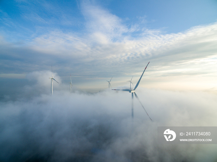 Wind power generator before sunrise sunset ，Wind power generation in the sea of clouds