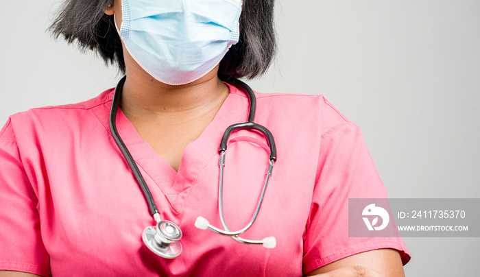 selective focus of black lady in uniform and a mask, with stethoscope- close up image of  african female health worker-