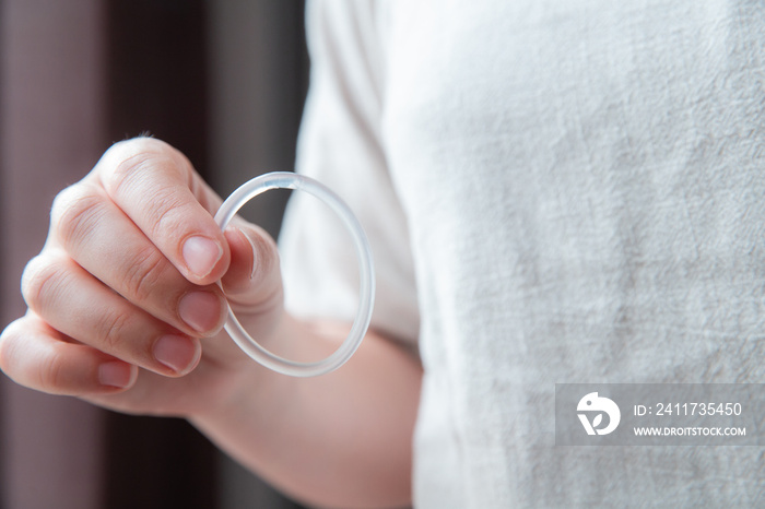 Woman’s hand holding a birth control ring, vaginal ring for contraceptive