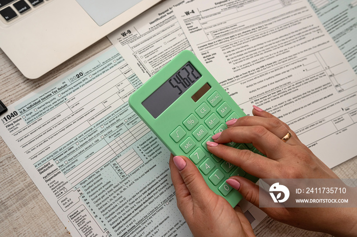 female hands filling individual income tax return 1040