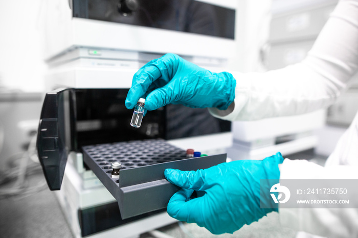 Professional female chemist researcher carrying out scientific research in a lab, industrial chemistry concept