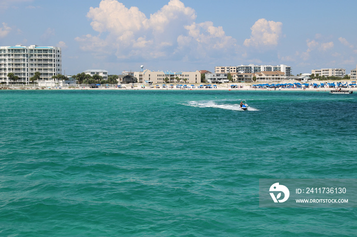 speedboat moving quickly through the ocean along the coastline