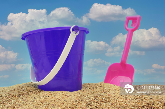 Sand Pail and Shovel on Beach With Blue Sky