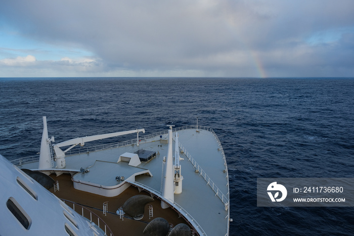 Rainbow at sea after storm during transatlantic passage on legendary ocean liner cruiseship cruise ship on Atlantic Ocean with cloud and seascape