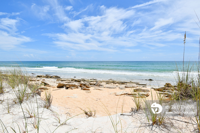 Coquina rocks on the beach along the coastline near Washington Oaks State Park in Palm Coast city in Florida