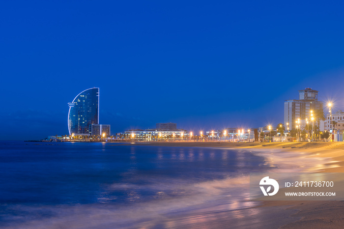 View of Barcelona Beach in summer night along seaside in Barcelona, Spain. Mediterranean Sea in Spain.