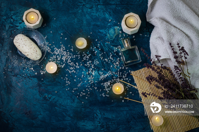 White Towel, Sea Bath Salt, Candles, Handmade Soap on a Dark Dark Blue Background