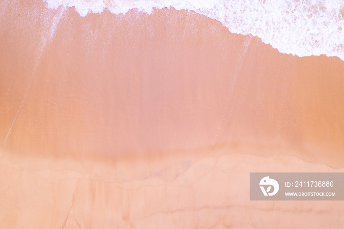 Beach Sand Sea Shore and waves white foamy summer sunny day background.Amazing beach top down view overhead seaside nature background