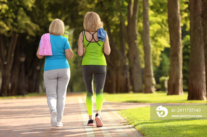 Sporty mature women after training in park